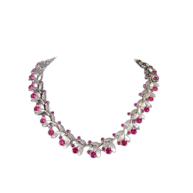 Light luxury, versatile, and retro-style white gold necklace featuring a leaf design and delicate purple rhinestones, exuding elegance and fashion