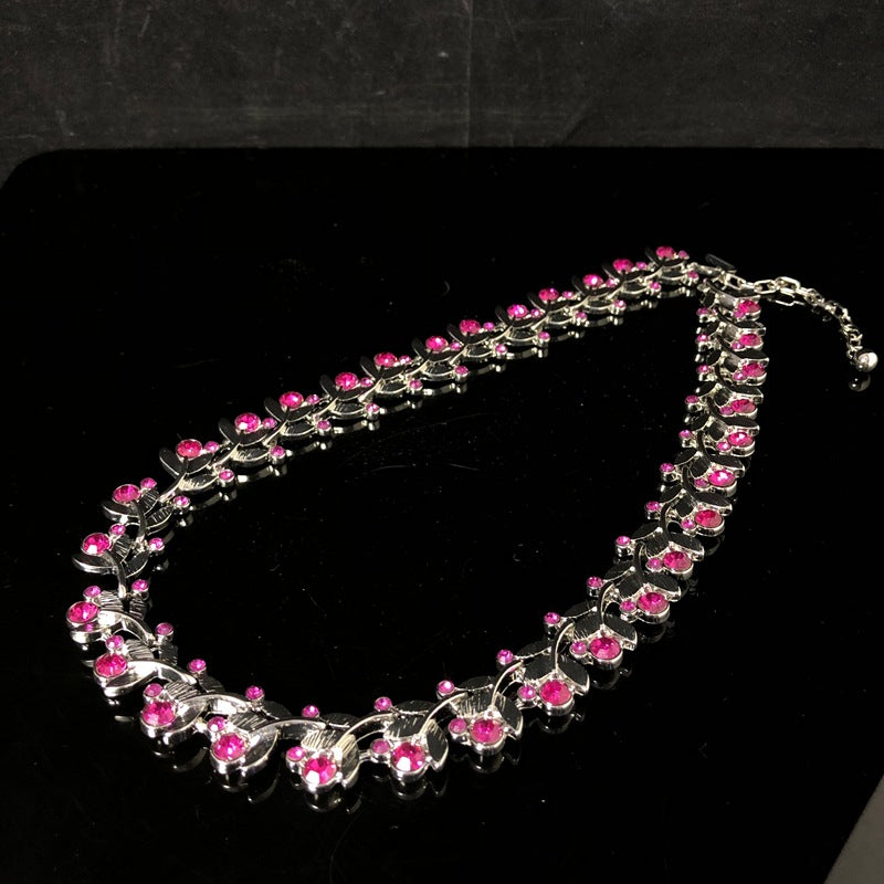 Light luxury, versatile, and retro-style white gold necklace featuring a leaf design and delicate purple rhinestones, exuding elegance and fashion