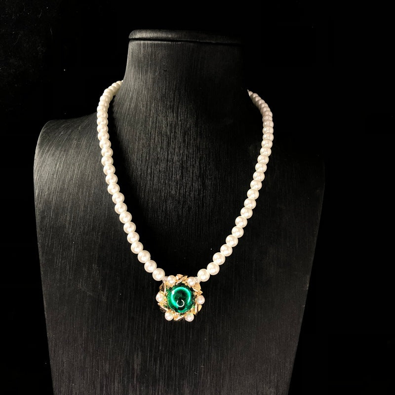 Vintage jewelry design, versatile pearl necklace with a green pendant, earrings, and a set of accessories – simple and stylish