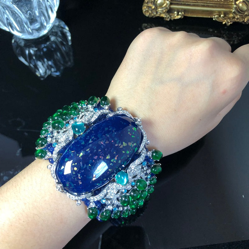 Vintage-style, intricately crafted blue beaded bracelet with rhinestone and green jelly resin accents, a fashionable wrist accessory