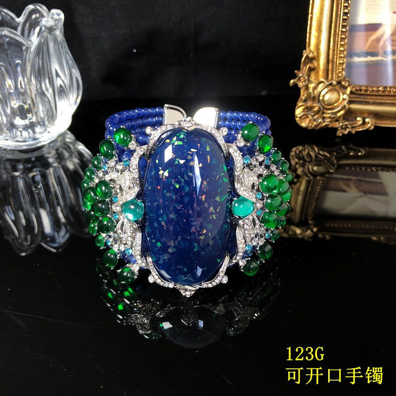 Vintage-style, intricately crafted blue beaded bracelet with rhinestone and green jelly resin accents, a fashionable wrist accessory