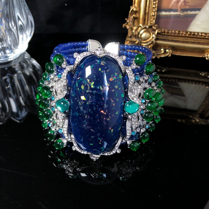 Vintage-style, intricately crafted blue beaded bracelet with rhinestone and green jelly resin accents, a fashionable wrist accessory