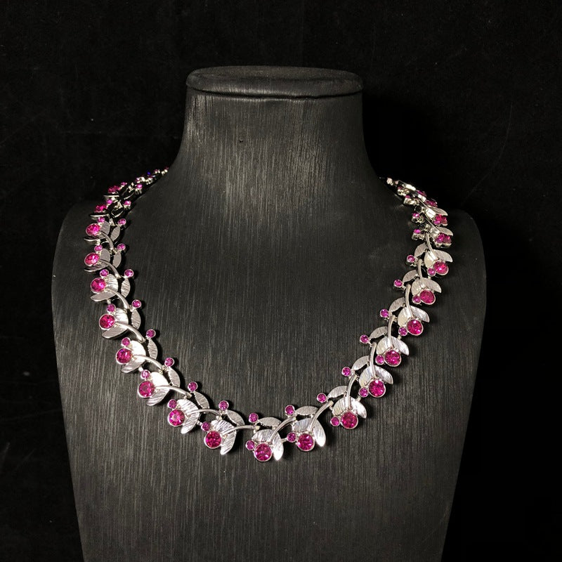 Light luxury, versatile, and retro-style white gold necklace featuring a leaf design and delicate purple rhinestones, exuding elegance and fashion