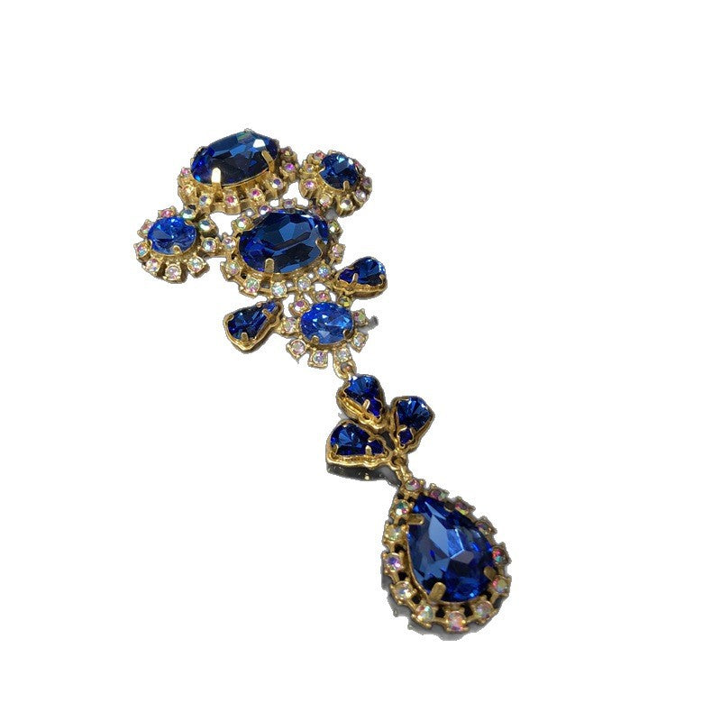 Vintage-style, exquisite, and luxurious brooch with diamond accents, featuring a classic design, a blue hue, and a sophisticated aesthetic, with copper settings and an aged finish