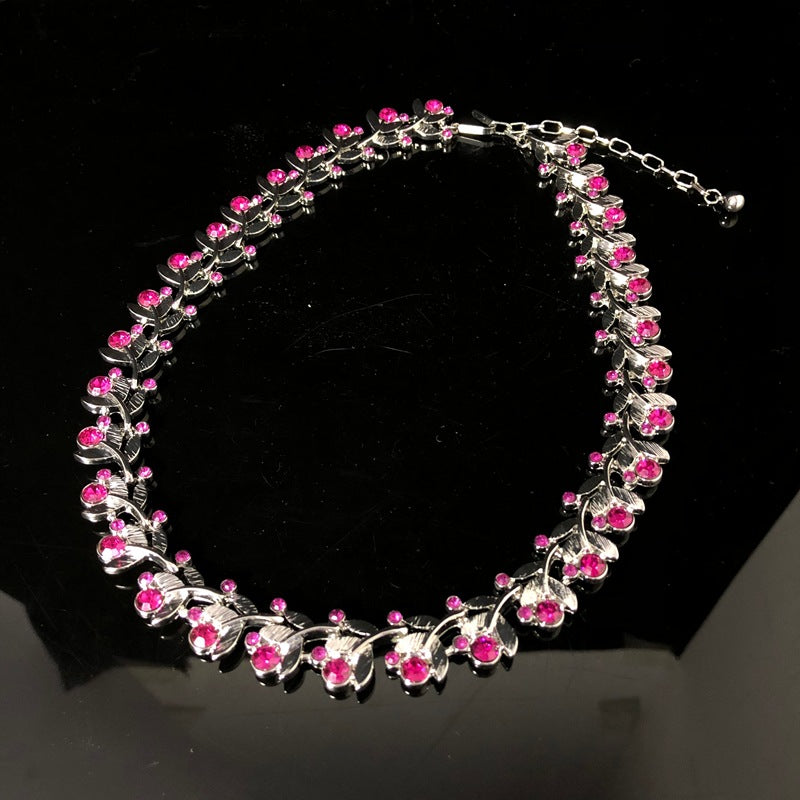 Light luxury, versatile, and retro-style white gold necklace featuring a leaf design and delicate purple rhinestones, exuding elegance and fashion