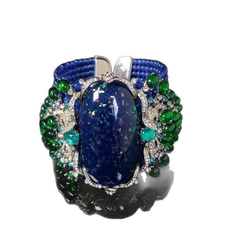 Vintage-style, intricately crafted blue beaded bracelet with rhinestone and green jelly resin accents, a fashionable wrist accessory