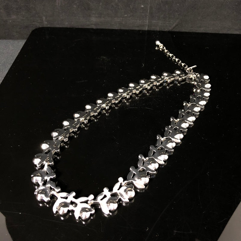Light luxury, versatile, and retro-style white gold necklace featuring a leaf design and delicate purple rhinestones, exuding elegance and fashion