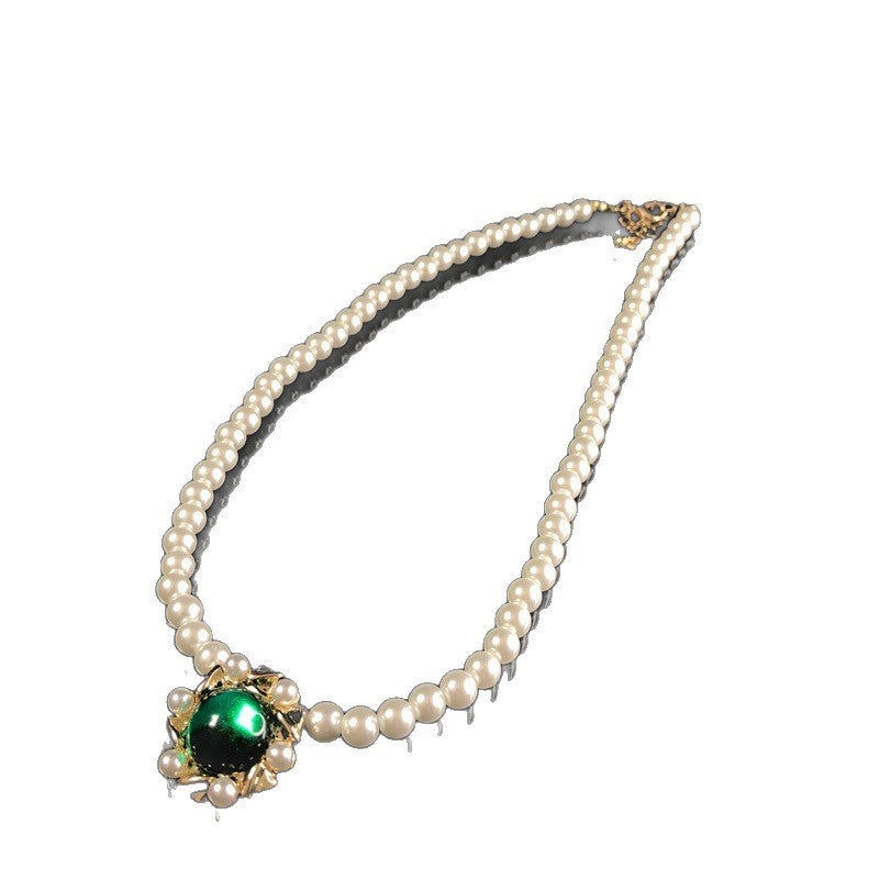 Vintage jewelry design, versatile pearl necklace with a green pendant, earrings, and a set of accessories – simple and stylish